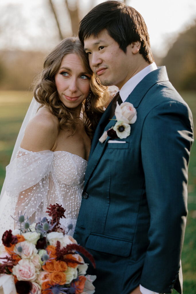 Bride and groom looking into the distance with peaceful faces.