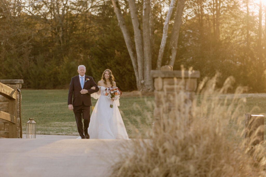 A bride walking with her father down the aisle.