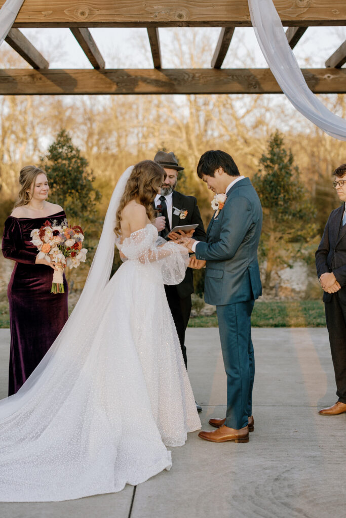 The bride and groom at the altar exchanging rings. 