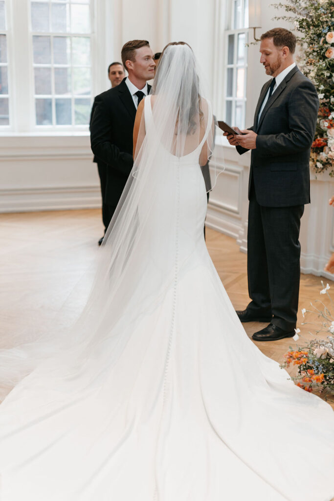 A wedding officiant conducts a wedding ceremony with the bride and groom