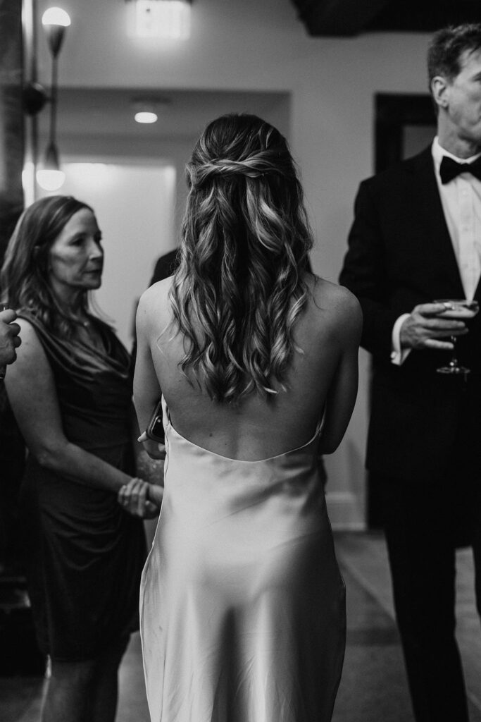 Three wedding guests talking together