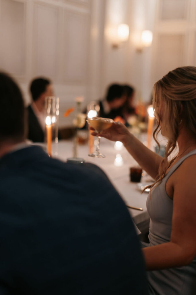 Guests raising their drinks at a wedding reception