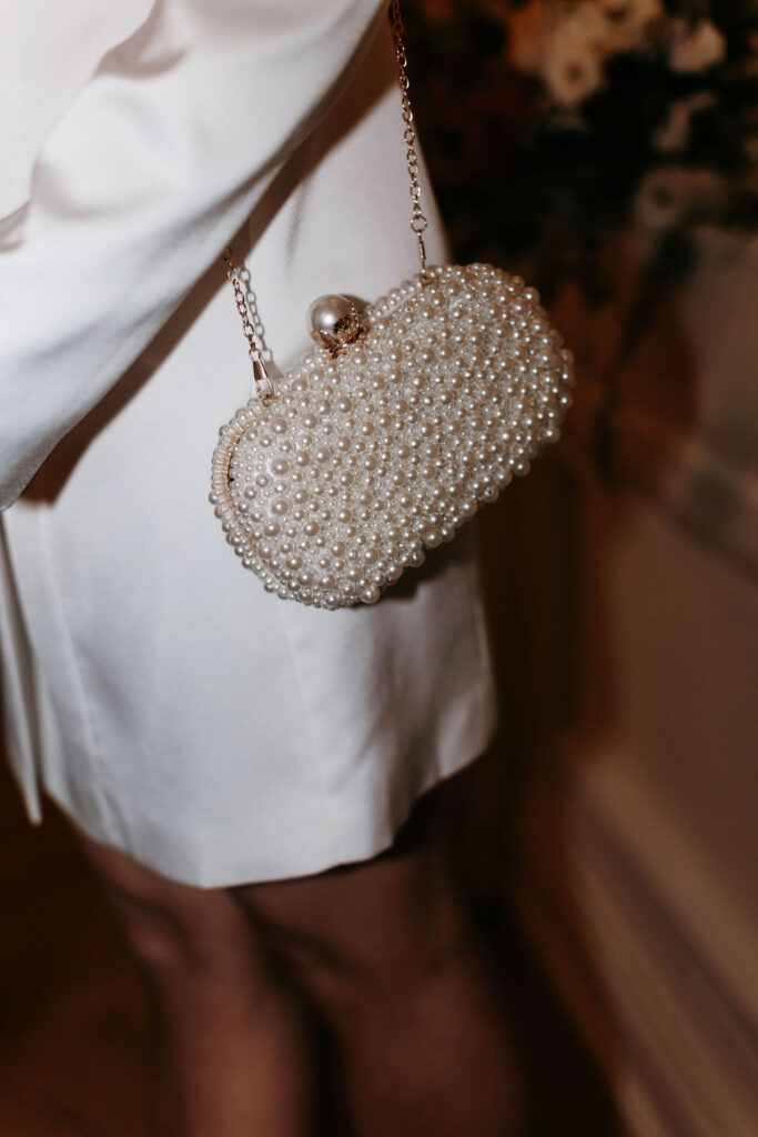 A detail photo of a pearl covered clutch with gold details