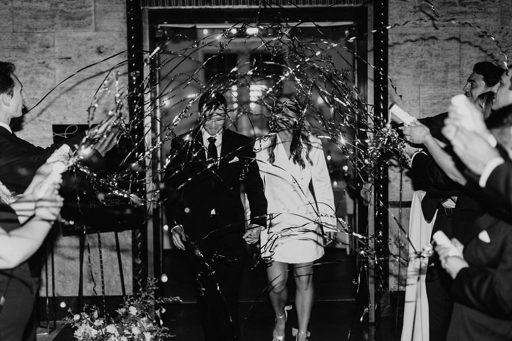 A bride and groom send off with silver streamers