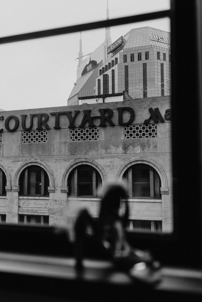 Nashville skyline including Courtyard Marriott hotel and Regions Bank building from inside a window.