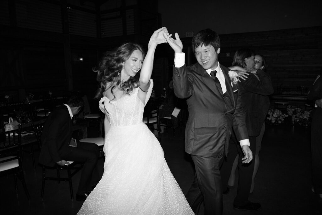 bride and groom dance happily together at their wedding reception